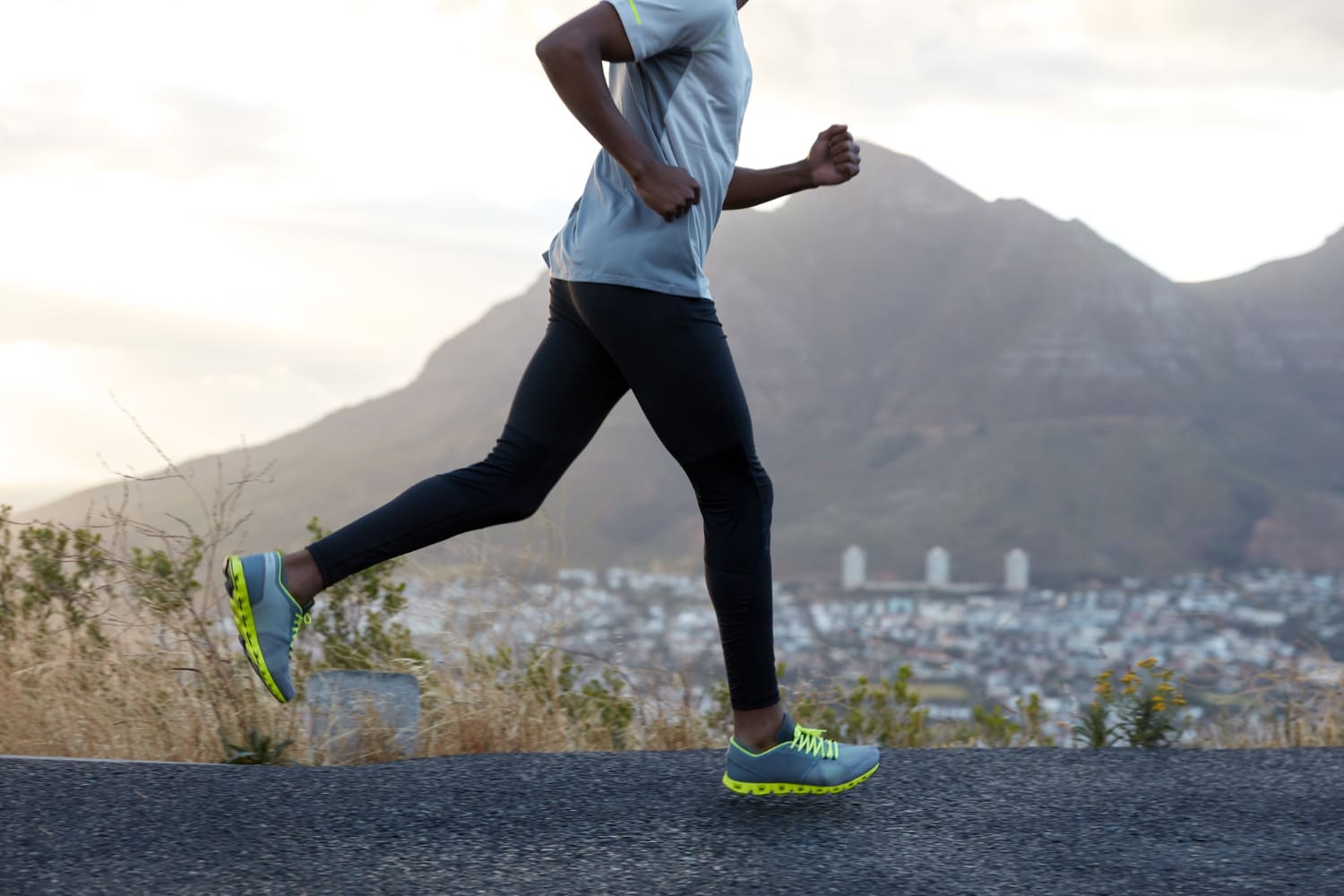 A closeup of a man wearing running pants for marathon training while running