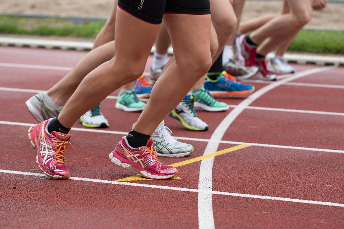 Group of runners participating in a marathon, showcasing the durability and support of their ultra marathon running shoes.