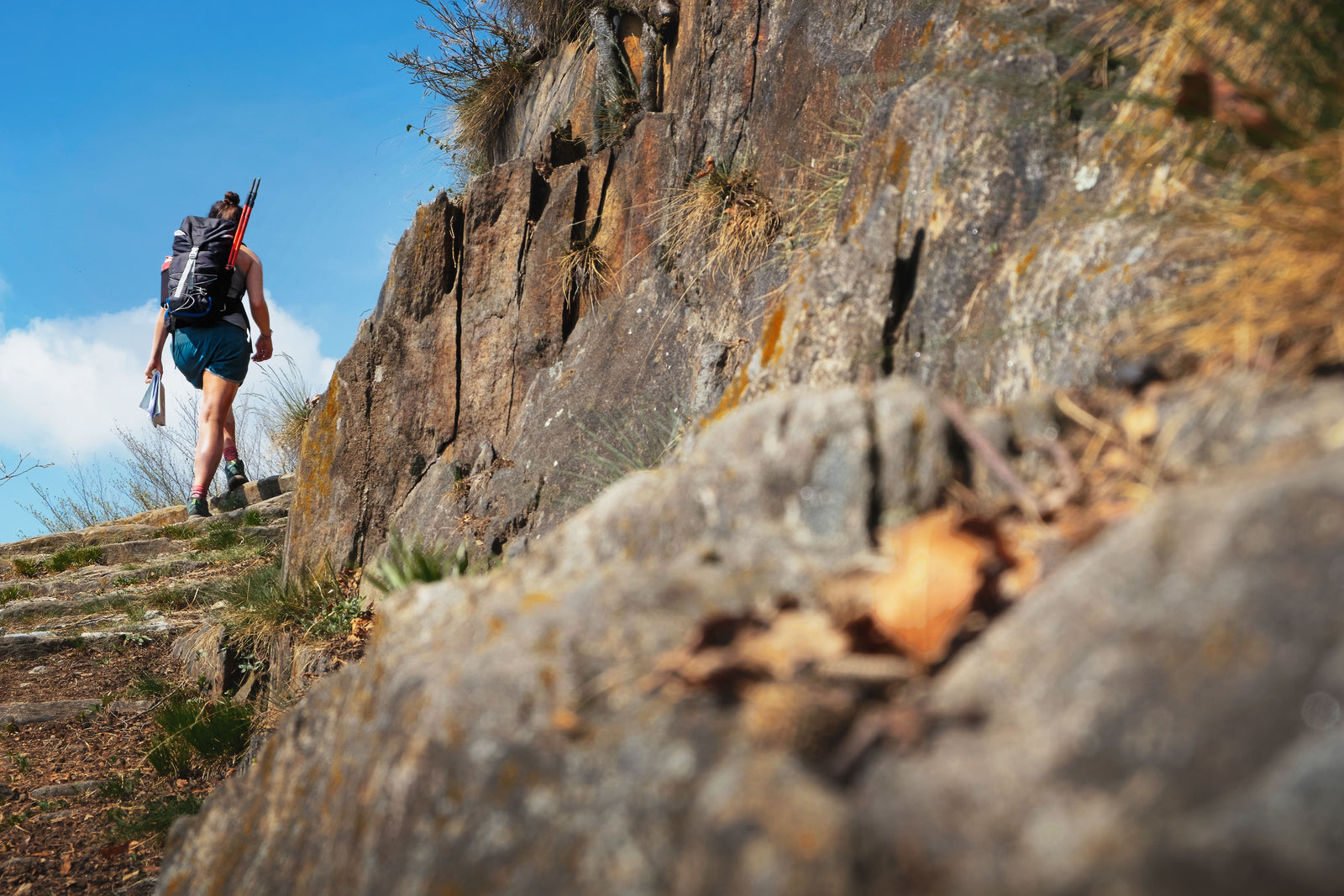 Women walking around the bend of a mountainous trai