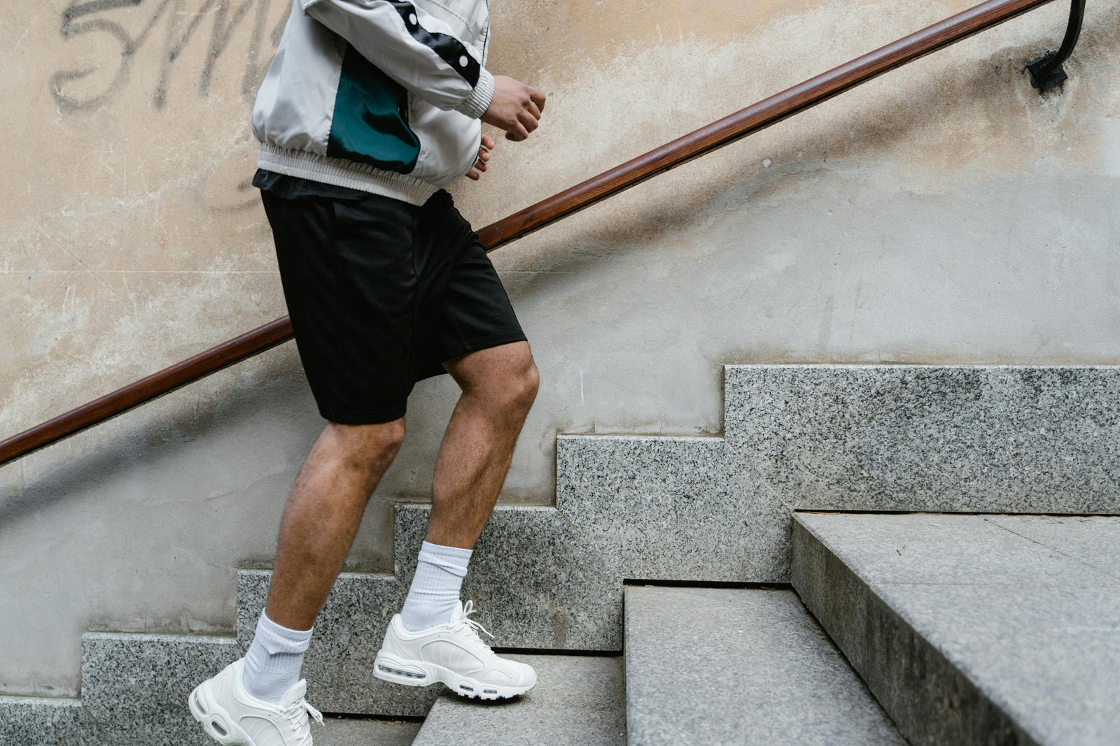 A man running up stairs showcasing top running shorts for men