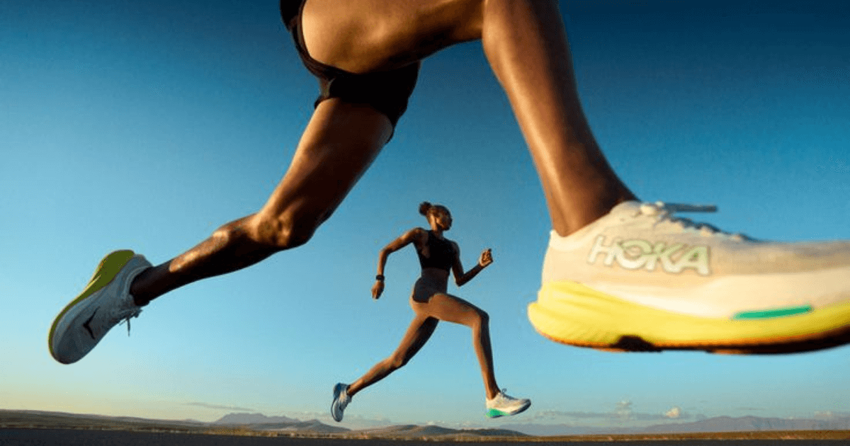 Two runners in South African HOKA running shoes mid-stride on an open road
