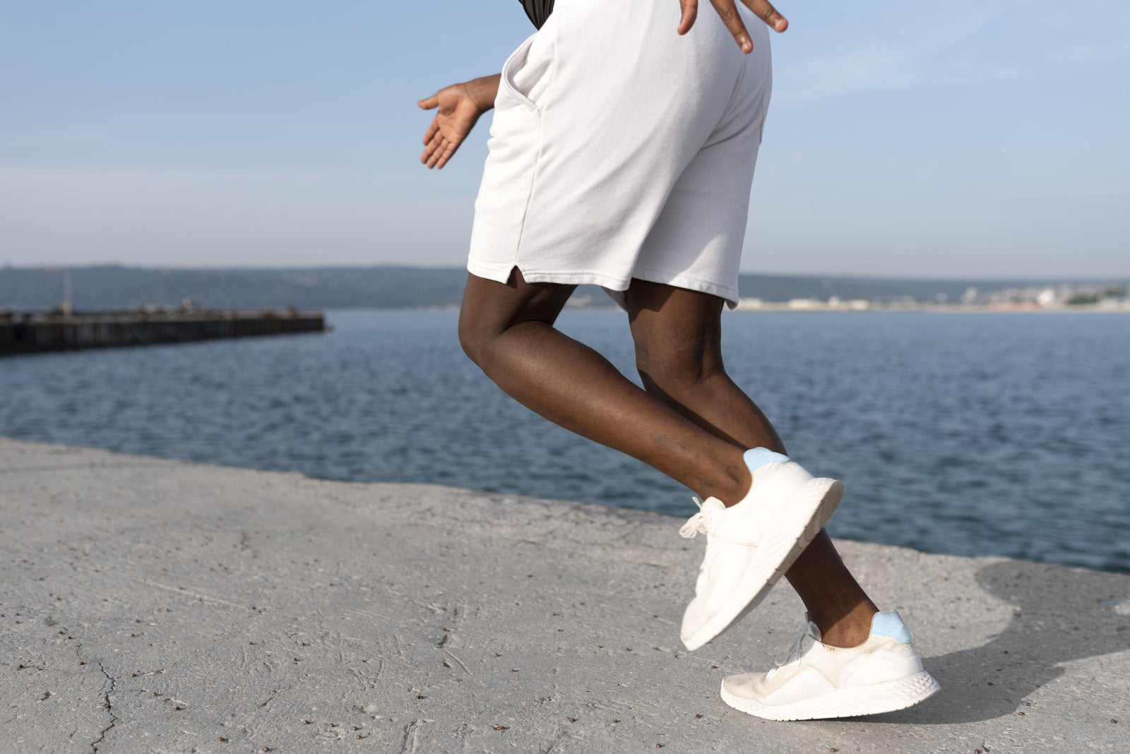 Man in sportswear outdoors exercising in the best white trainers