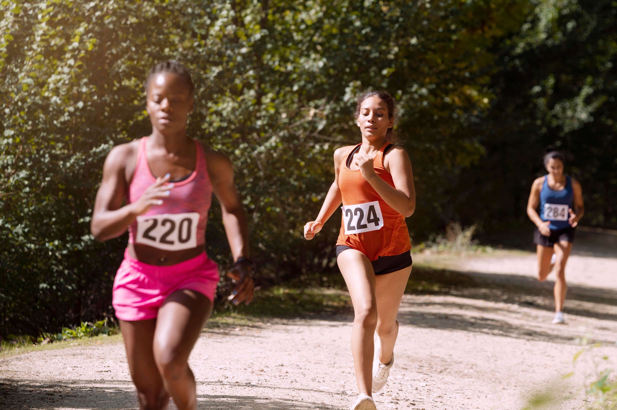 3 ladies completing a long distance race in their best marathon running gear 