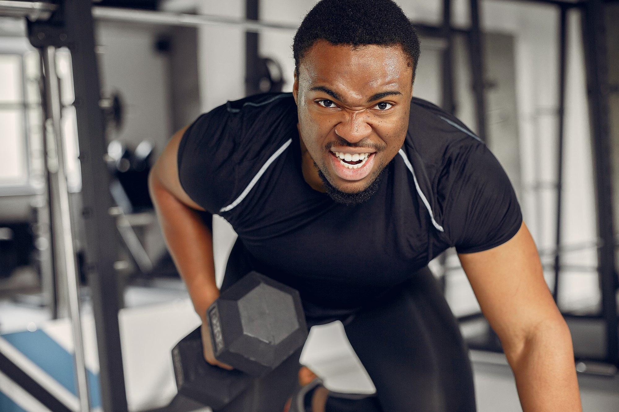 Black man exercising at the gym in men’s sports clothes