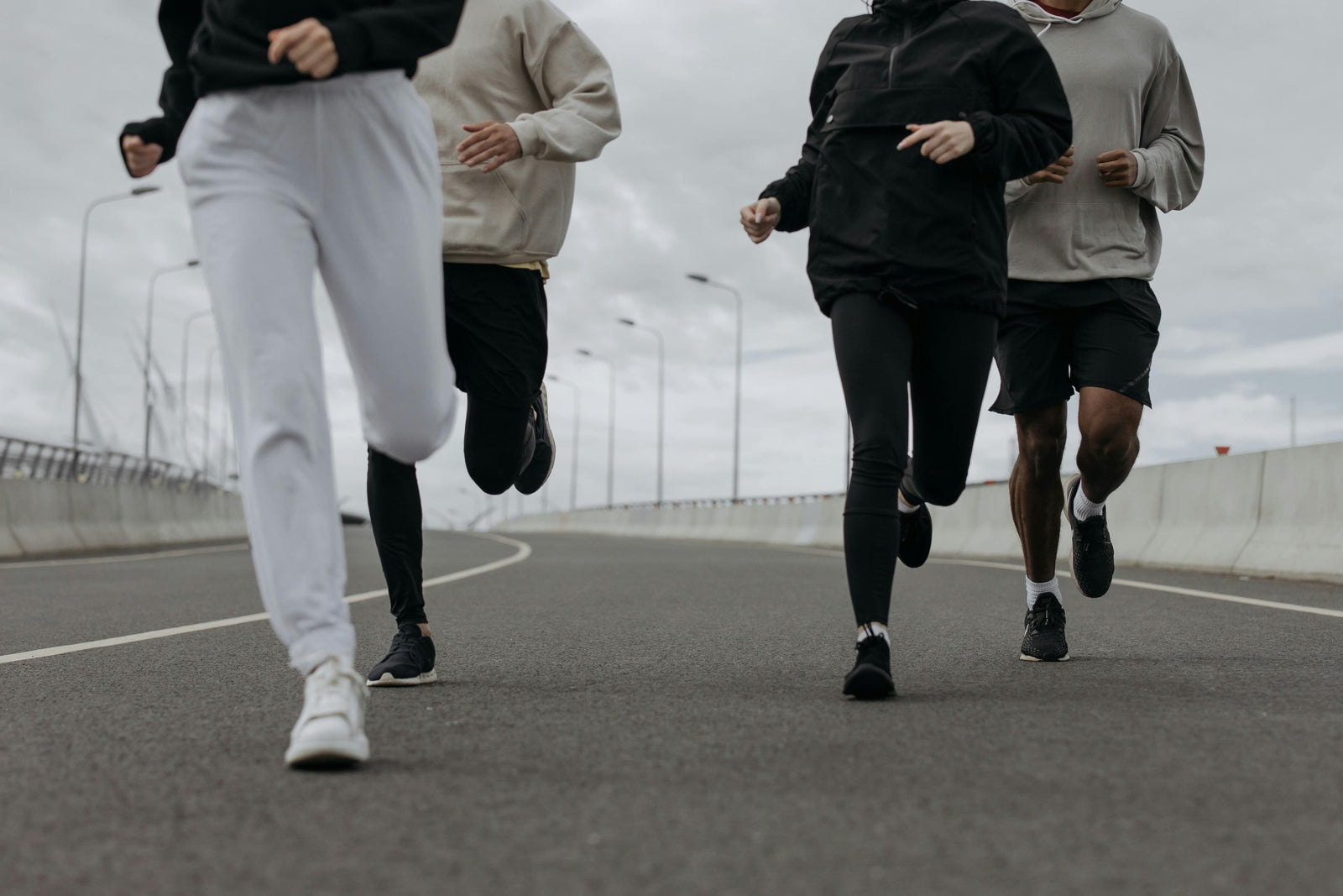 A group of runners wearing pants and shorts