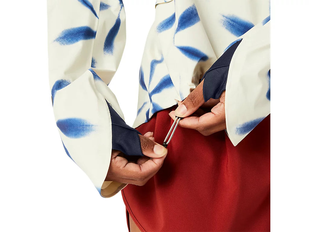 Hands adjusting a cinch cord on the bottom hem of a women&#39;s jacket from athlete&#39;s foot.